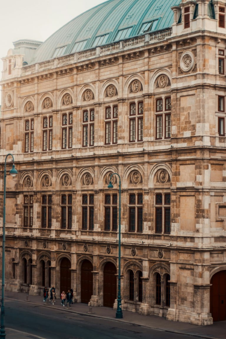 The Vienna Opera House, characterized by its large structure and distinctive dome, exemplifies stunning architectural design.